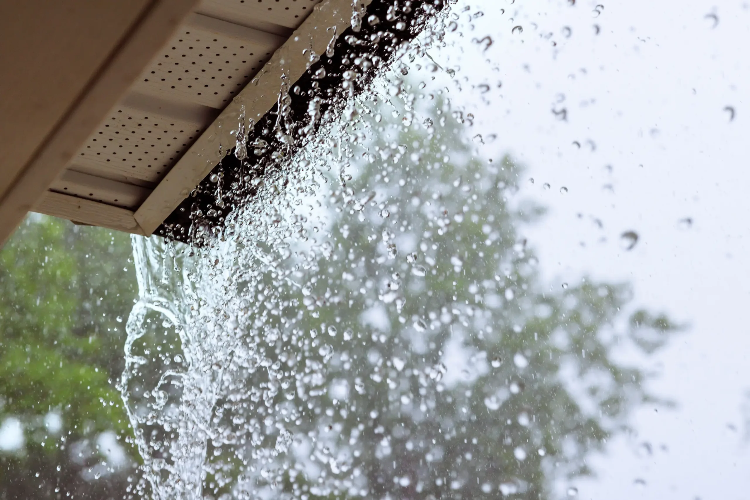 Overflowing rain gutter on a Delaware home highlighting gutter issues addressed by WOW Roofing & Gutters' gutter services.