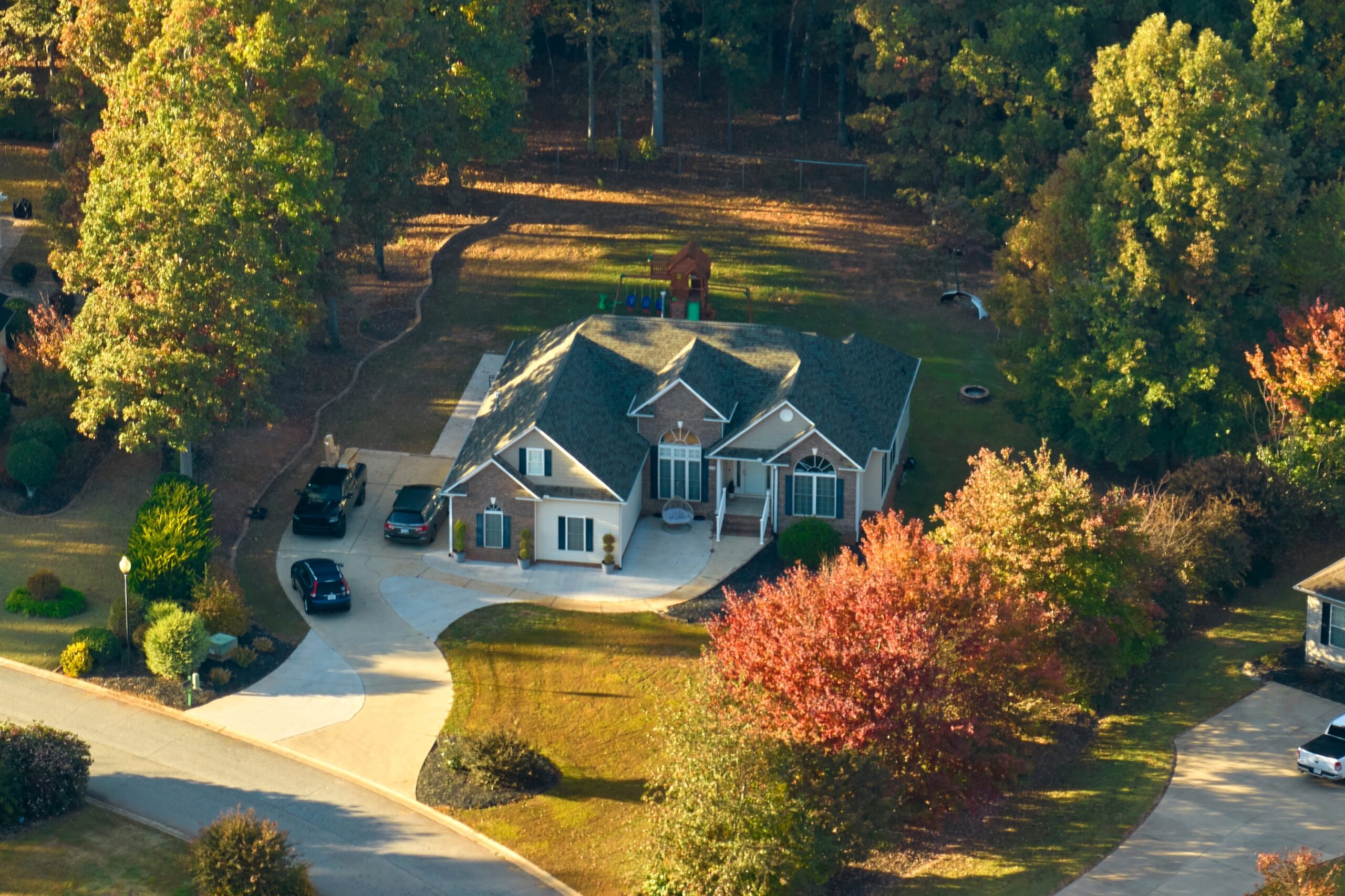 Aerial view of a residential home scheduled for a professional roof inspection by WOW Roofing & Gutters.