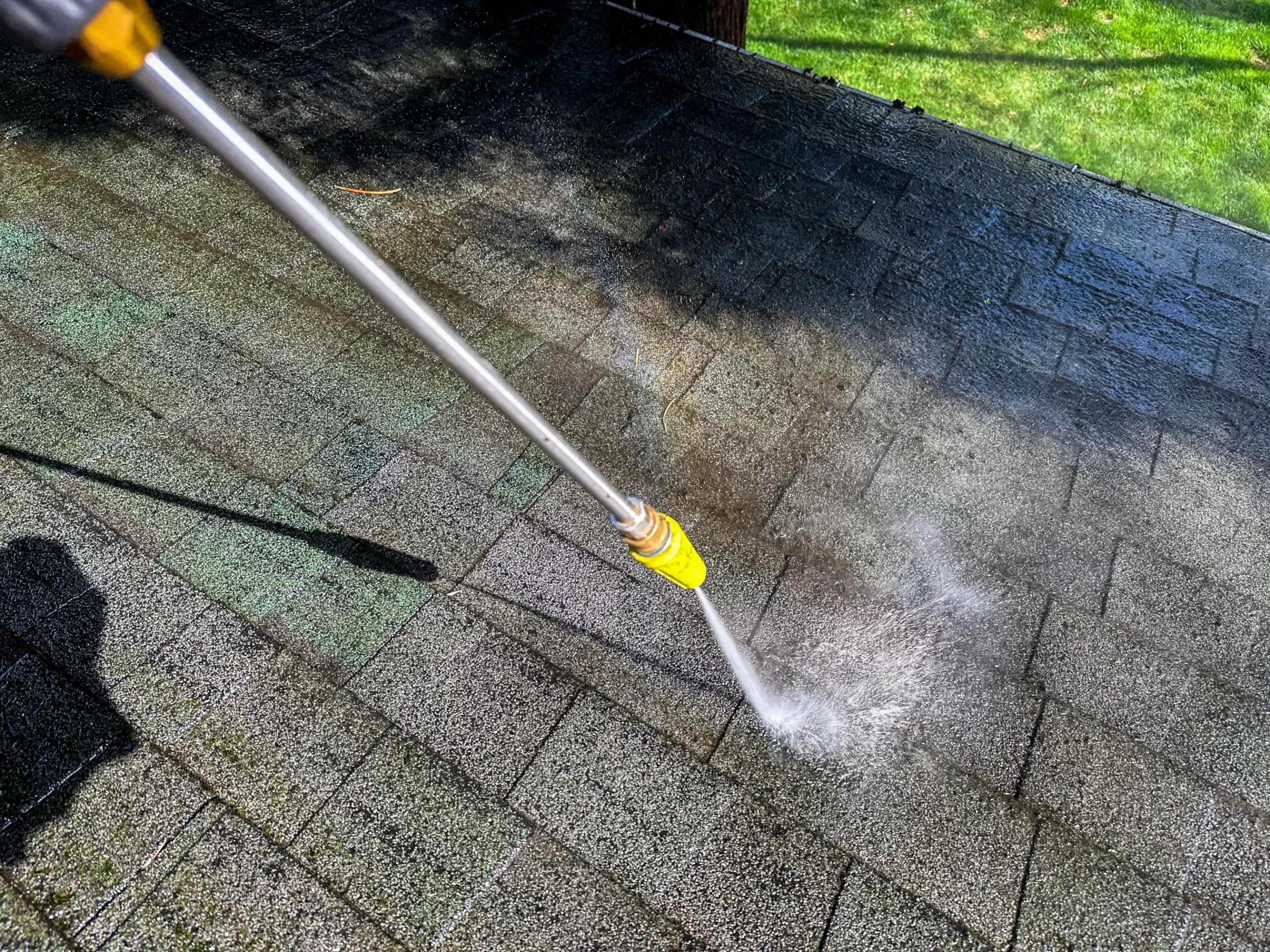 Roof rejuvenation treatment being applied to an asphalt shingle roof by WOW Roofing & Gutters.