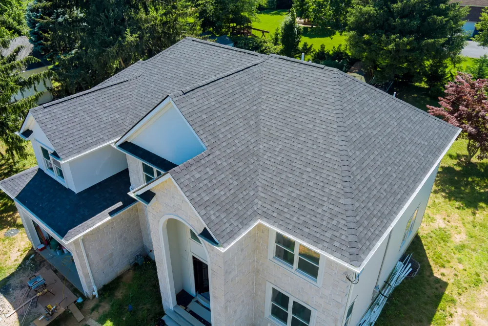 WOW Roofing & Gutters residential roofing installation featuring a gray shingle roof on a two-story home in Delaware.